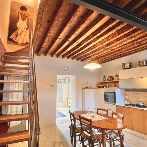 Kitchen and dining room with exposed wooden beams